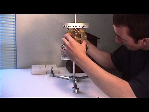 Clock Repair Basics. Clock movement test stand, assembly supports, clamping sets and brackets
