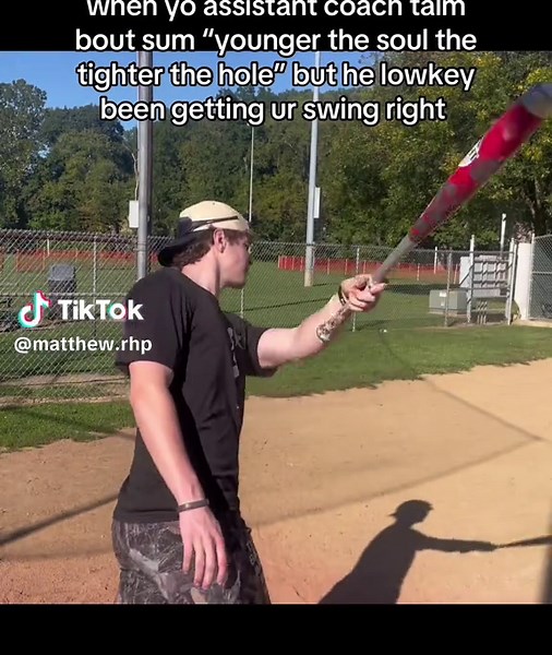 Pitcher Using a Baseball Bat in Action